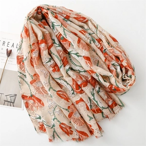 Detail of beige cotton linen scarf with orange poppy floral print and fringed edges