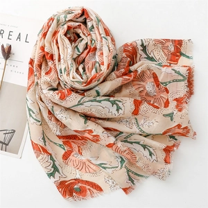 Detail of floral linen-feel scarf with golden peony print and frayed edge design
