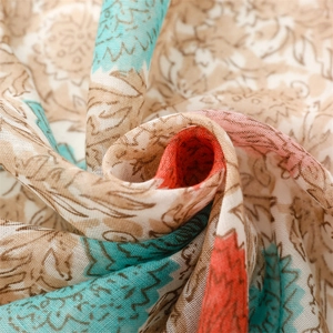 Detailed close-up of floral print voile scarf showing soft weave texture and vibrant colors