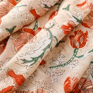 Detail of light orange cotton linen scarf with gold tulip prints and metallic foil edges