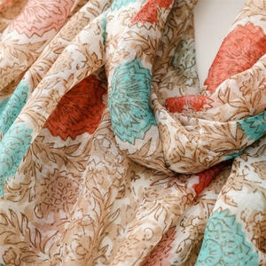 Close-up of soft floral pattern scarf with bohemian print and delicate fringe detail