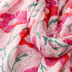 Detailed close-up of pink cotton scarf with gold foil floral pattern and soft texture