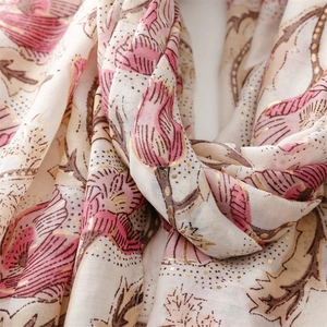 Detail of gold foil floral print and soft cotton-linen texture on a vintage scarf
