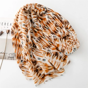 Detail of cotton-linen scarf with geometric gold stamping and ethnic prints and fringe