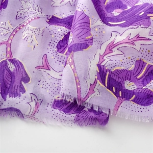 Detail of purple floral scarf with golden foil peonies and frayed edge texture