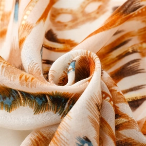 Detail shot of cotton-linen feel scarf with gold stamping and geometric feather texture