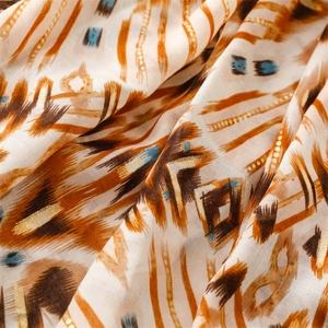 Close-up of bohemian geometric scarf fabric with gold foil details and soft texture