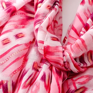 Detail of pink cotton-linen shawl featuring gold foil geometric patterns and fine metallic threads