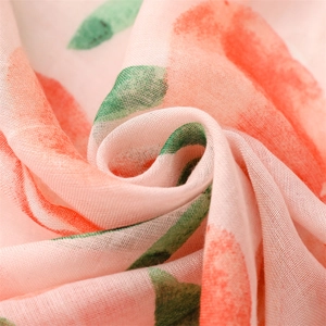 Detailed macro view of light cotton linen fabric with watercolor peach and leaf patterns