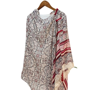 Oriental floral shawl with red Chinese buttons and tassel fringe on a wooden hanger