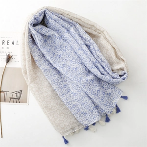 Floral cotton linen scarf with blue flower print and bicolor tassels on white background