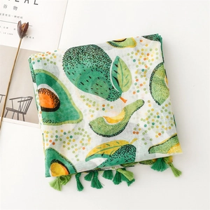 Detail of avocado print scarf with green tassels and natural linen texture feel