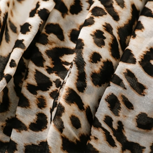 Macro detail of breathable leopard print scarf fabric showing soft texture and natural folds