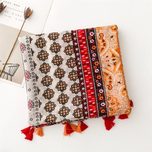Detail of bohemian scarf with ethnic floral patterns and delicate fringe tassels