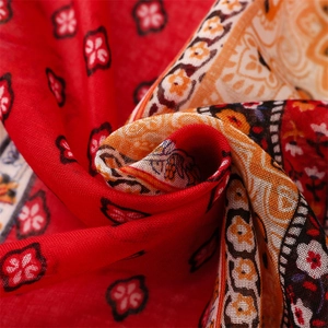 Detailed macro view of the vibrant red bohemian print fabric with soft folds and texture