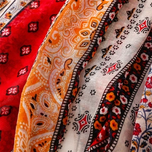 Close-up of exotic bohemian scarf fabric showing intricate paisley patterns and soft texture
