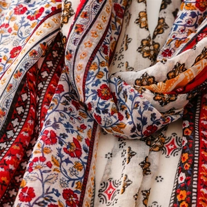 Detail view of ethnic floral patterns and fabric texture on a bohemian summer shawl