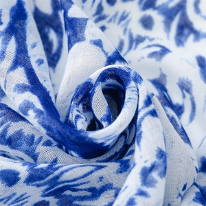 Macro shot of breathable linen texture with blue floral porcelain print patterns