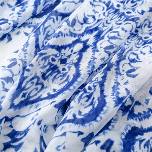 Close-up of blue and white floral scarf fabric with breathable cotton linen texture