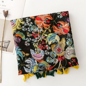 Artistic scarf with vibrant floral and bird prints featuring yellow and green tassels