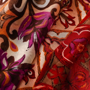 Macro shot of ethnic boho floral print shawl showing rich colors and weave texture