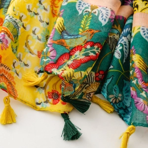 Detailed close-up of ethnic floral print scarf with birds and handcrafted tassels