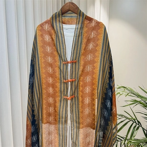 Detail of retro ethnic shawl with geometric patterns and handmade button closure