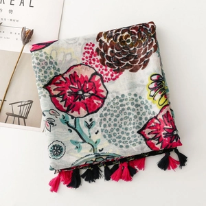 Detail of vibrant floral scarf with cotton-linen feel and dual-color fringe tassels