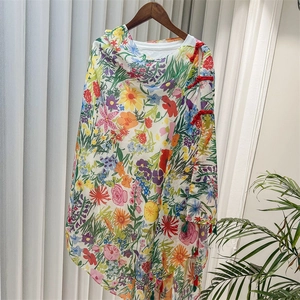 Detail of floral chiffon shawl with traditional Chinese button and bright botanical print
