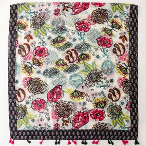 Colorful floral print scarf with vibrant flower patterns and black fringe tassels