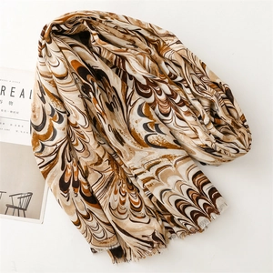 Detail of bohemian cotton-linen scarf with brown marble floral print and frayed edges