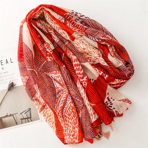 Orange leaf print cotton-linen feel shawl with fringe tassels and tropical patterns