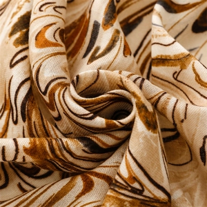 Macro shot of cotton linen shawl showing beige marble pattern and woven texture details