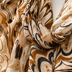 Detail of soft cotton linen scarf with earthy marble pattern and woven fiber texture