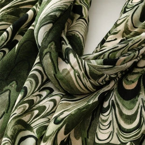 Close-up of green marble swirl pattern on premium cotton linen scarf with soft texture
