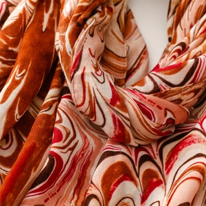 Detailed macro view of the marble pattern fabric with fringe edges on the warm scarf