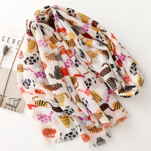 Detail of cotton linen scarf with colorful cartoon cat patterns and frayed edge