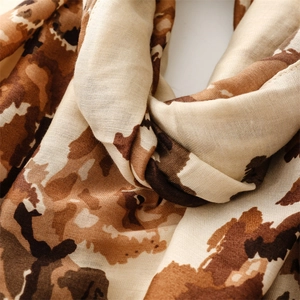 Close-up of leopard pattern scarf with soft cotton-linen texture and earthy tones