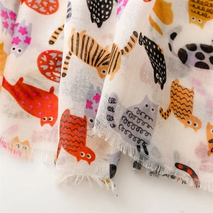 Detail view of cotton-linen feel scarf showing cute cat prints and natural frayed edges