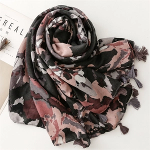 Detailed view of scarf with abstract print and delicate handmade fringe tassels