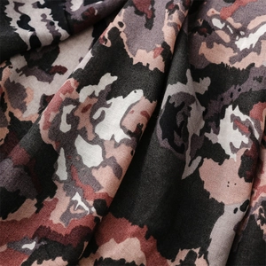 Macro detail of abstract leopard print fabric showing soft texture and fringe edges