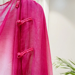 Detail view of the rose red Chinese style scarf featuring traditional handmade frog buttons