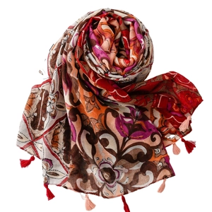 Ethnic bohemian print shawl with tassels and vintage floral patterns in vibrant red and orange