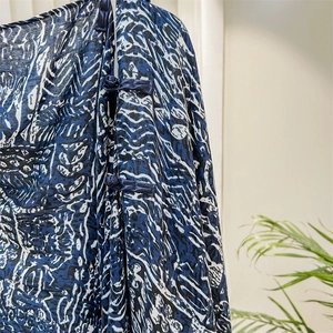 Close-up of traditional Chinese knots on abstract printed silk scarf fabric