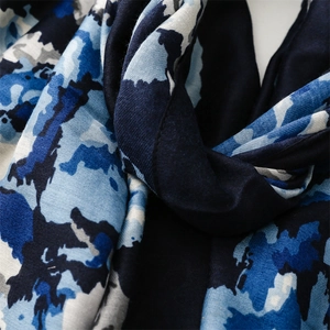 Detail of blue abstract floral scarf showing soft cotton-linen texture and weaving