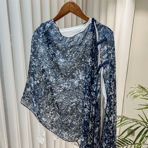Close-up of blue floral chiffon shawl featuring traditional Chinese frog button detail