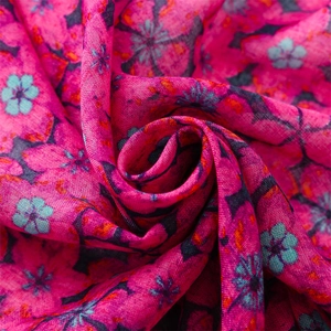 Detailed close-up of rose pink floral scarf fabric showing light weave texture