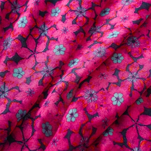 Detailed macro view of the rose pink scarf fabric with delicate cherry blossom patterns