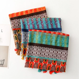 Detailed close-up of Bohemian geometric scarves with colorful tassels and ethnic prints