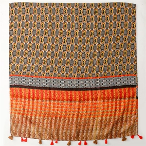 Detail of bohemian scarf showing geometric patterns, tribal prints and handmade fringe